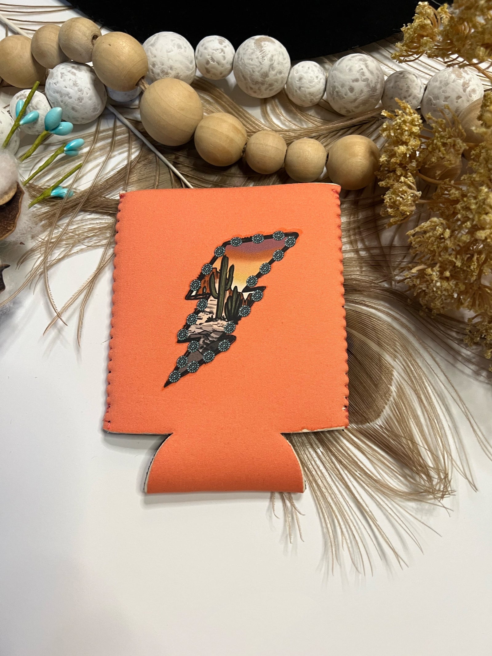 Pictured is a coral koozie with a lightning bolt on it.